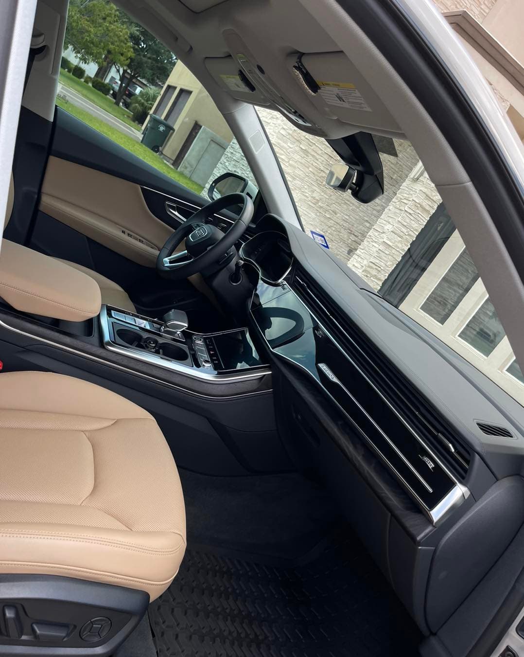 Spotless Audi Q7 cabin with tan leather seats and detailed dashboard after an interior clean